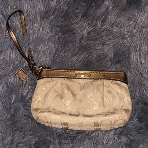 Gold and white Coach Wristlet